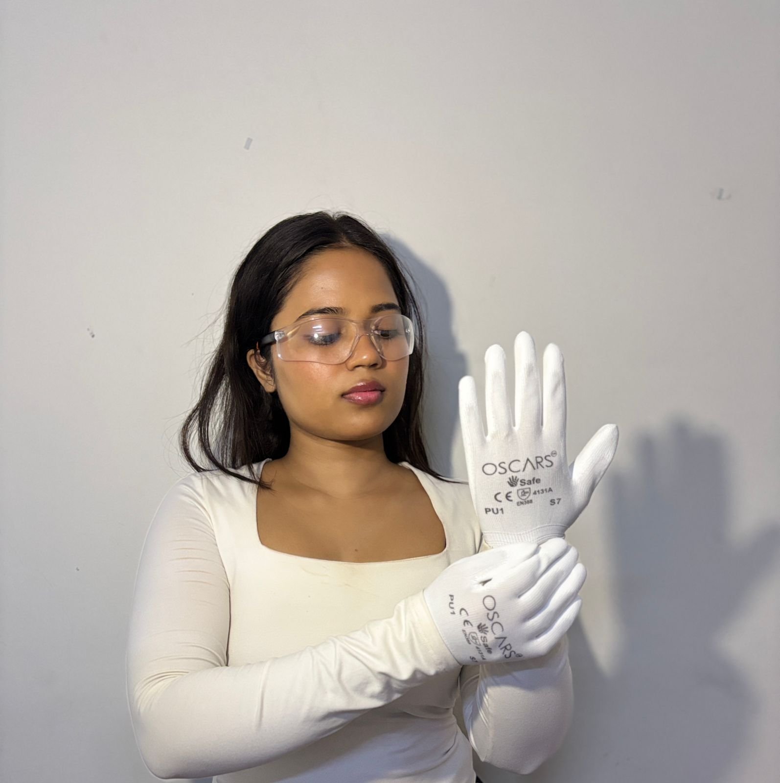 Oscars PU1 white safety gloves worn with safety eyewear